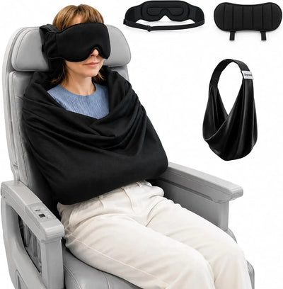 Woman enjoying a peaceful flight with a black sleep mask and travel pillow set.