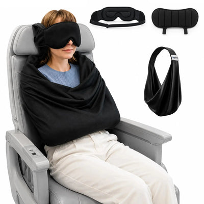 Female traveler wearing a black eye mask with a comfortable travel pillow during a flight.